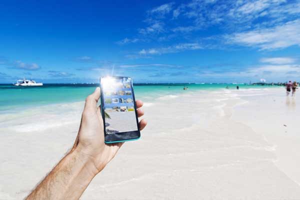 phone taking photo of beach